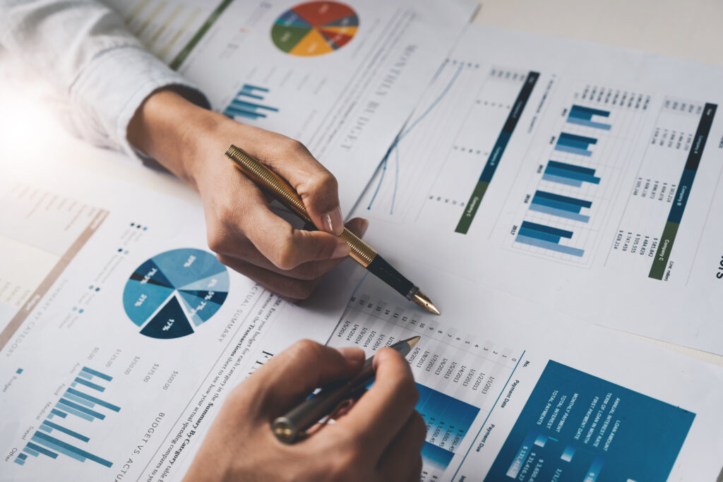 People reviewing financial spreadsheets and documents.